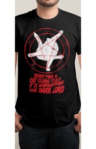 https://www.threadless.com/product/3592/EVERY_TIME_A_CAT_CLEANS_ITSELF_IT_IS_WORSHIPPING_THE_DARK_LORD/tab,guys/style,shirt?from=b.impossible